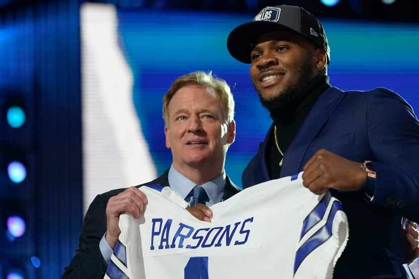 Penn State linebacker Micah Parsons, right, holds a team jersey with NFL Commissioner Roger...