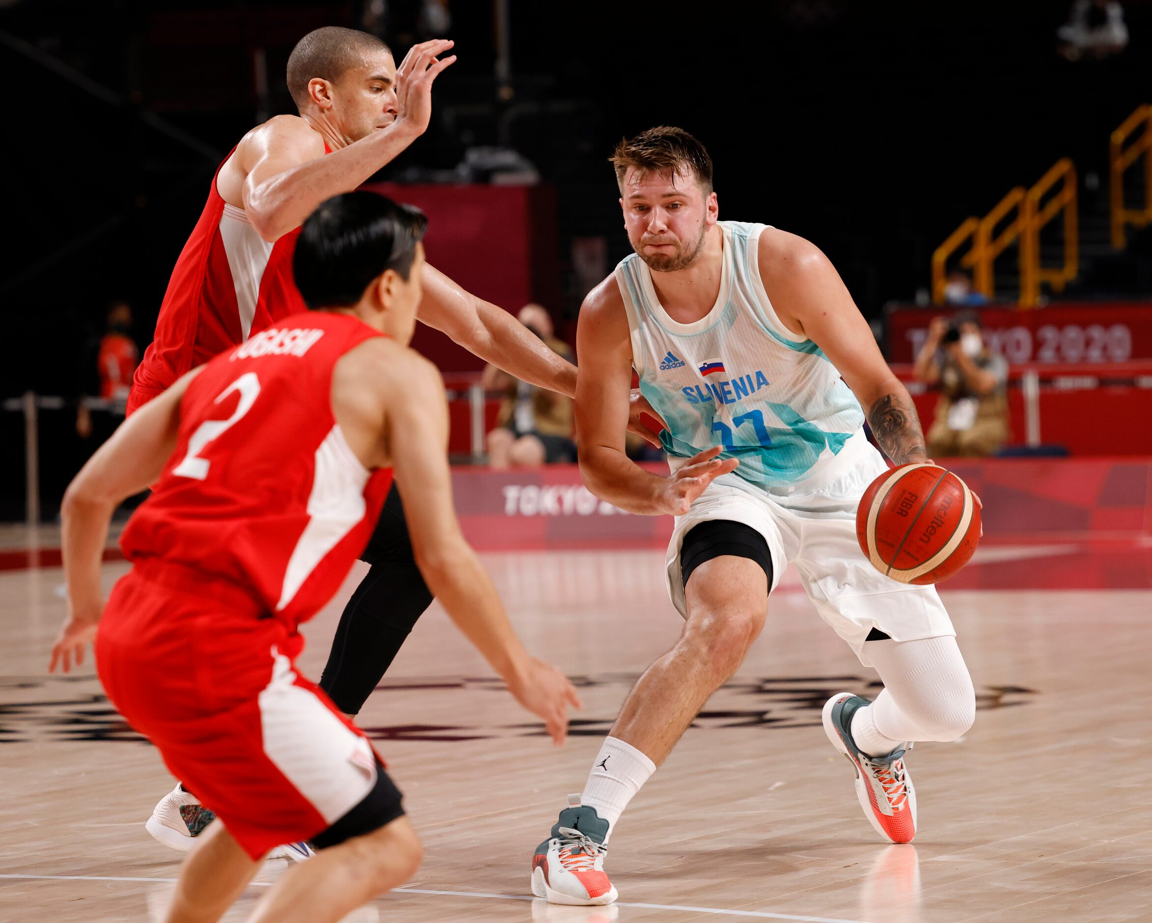 Slovenia’s Luka Doncic (77) steps back for a three point attempt as Japan’s Gavin Earl...