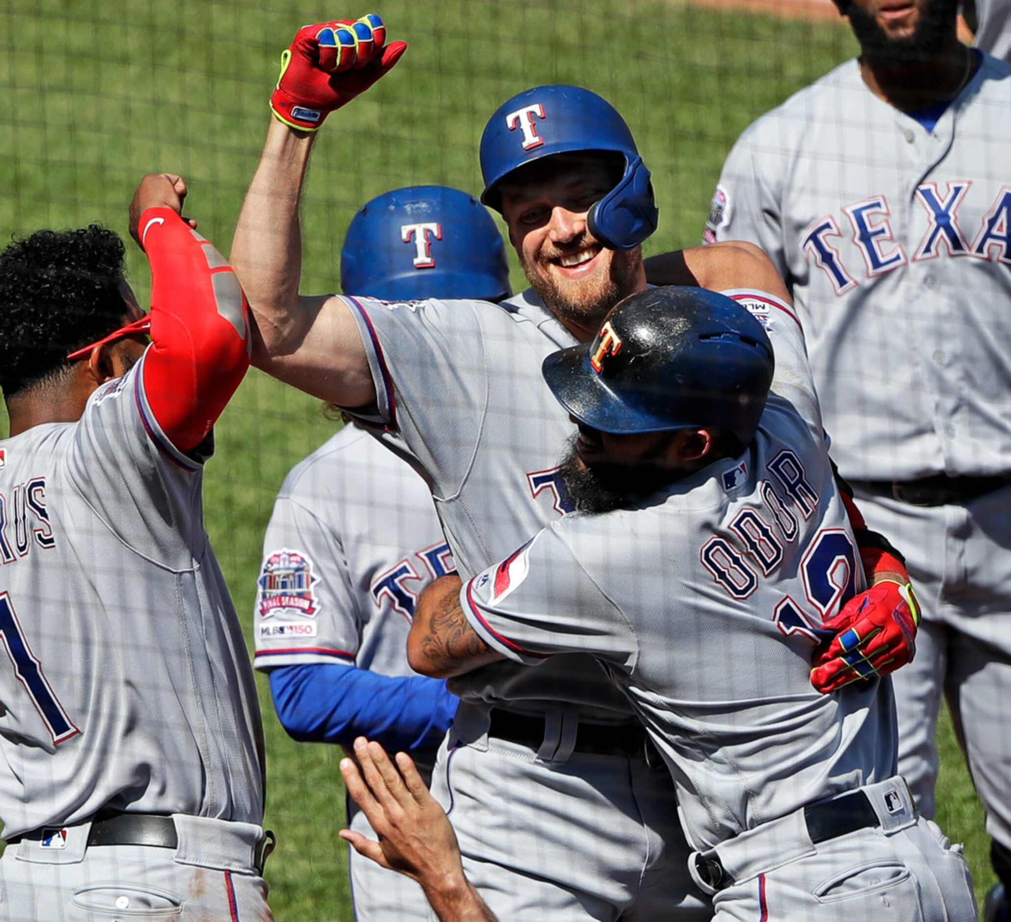 Texas Rangers' Hunter Pence, center, celebrates with Rougned Odor (12) and Elvis Andrus (1)...