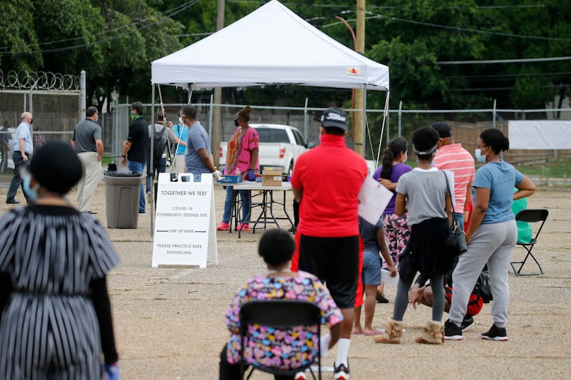 People wait in line to be tested for coronavirus at a free testing site in Dallas, on...