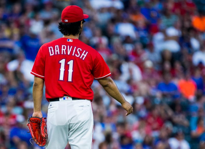 Texas Rangers starting pitcher Yu Darvish (11) shakes out his right arm during the fifth...