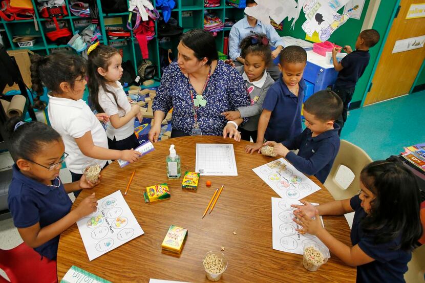 
Youngsters surrounded Laura Koenig in her prekindergarten classroom Tuesday at Cesar Chavez...