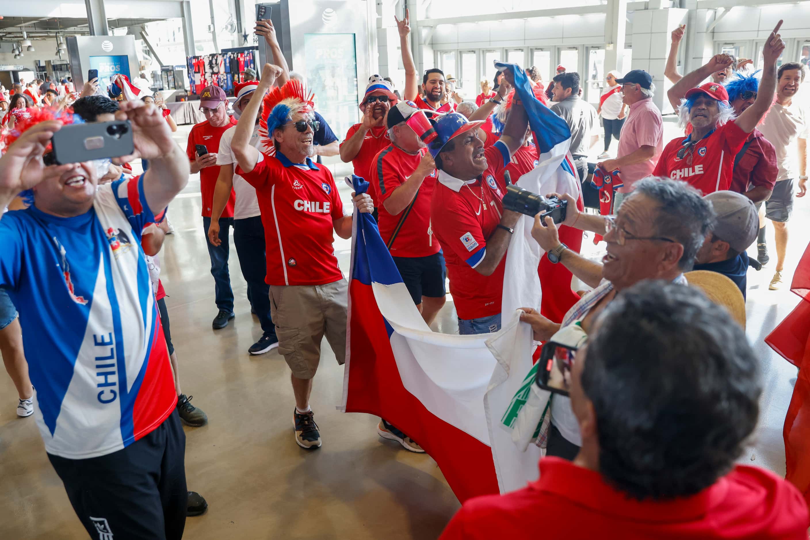 Chile soccer fans dance and sing on the concourse of AT&T Stadium before a Copa America...