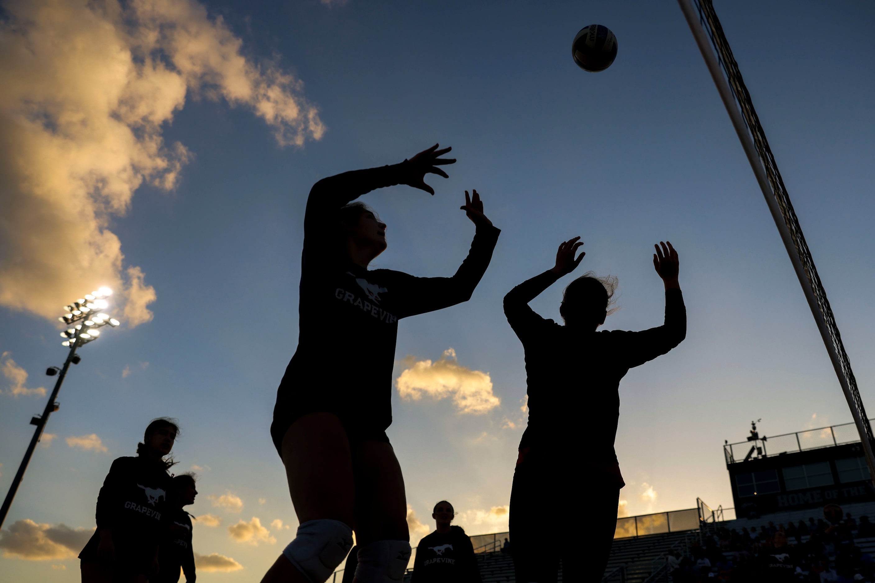 Grapevine High players warm up ahead of an outdoor volleyball game against Liberty Christian...