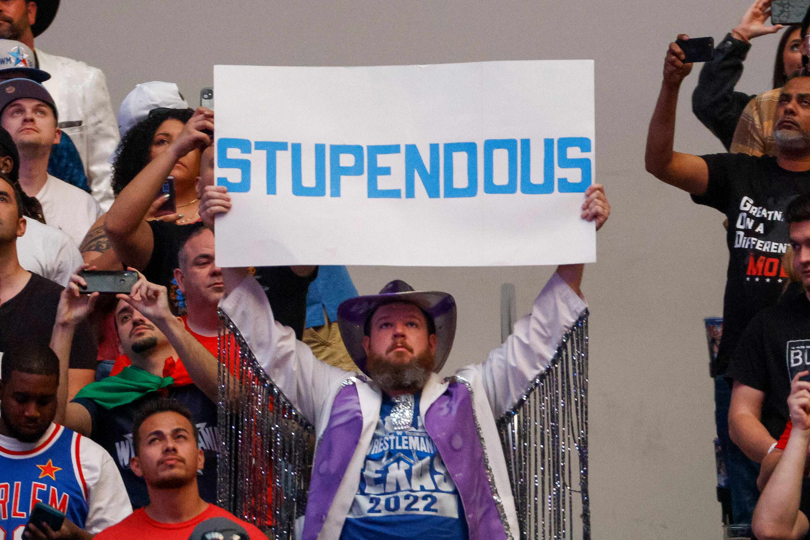 A fan raises a sign during WrestleMania Sunday at AT&T Stadium in Arlington, Texas, Sunday,...