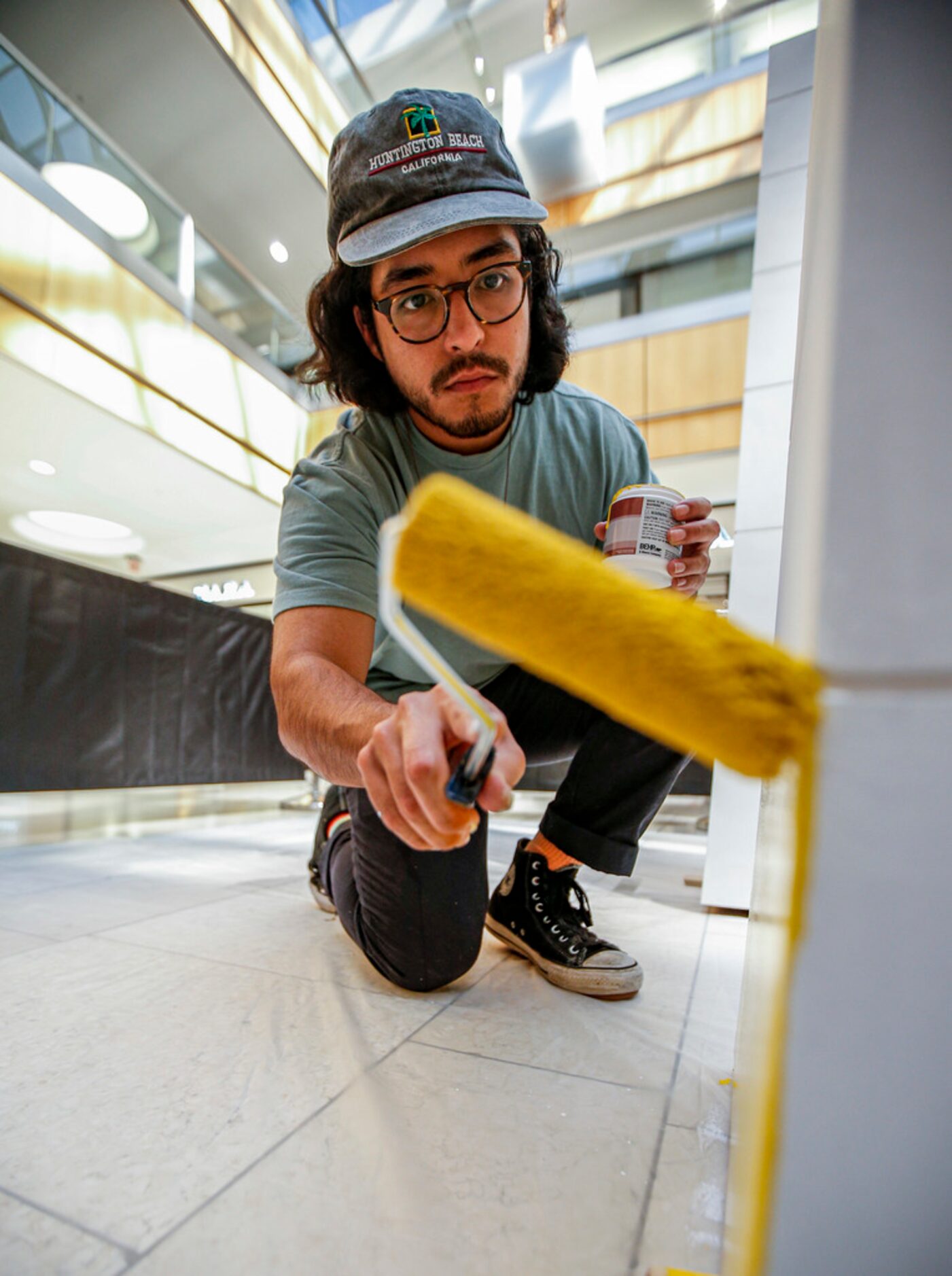 Artist Drigo, Eric Rodriguez, paints his sculpture "Growing Up' at the Galleria in Dallas....