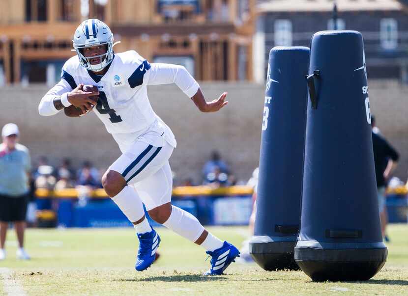 Dallas Cowboys quarterback Dak Prescott (4) runs a drill during a morning practice at...