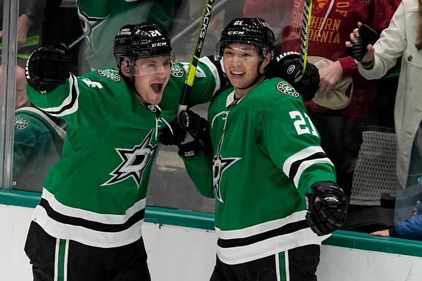 Dallas Stars' Roope Hintz (24), Jason Robertson (21) and Colin Miller (6) celebrate after...