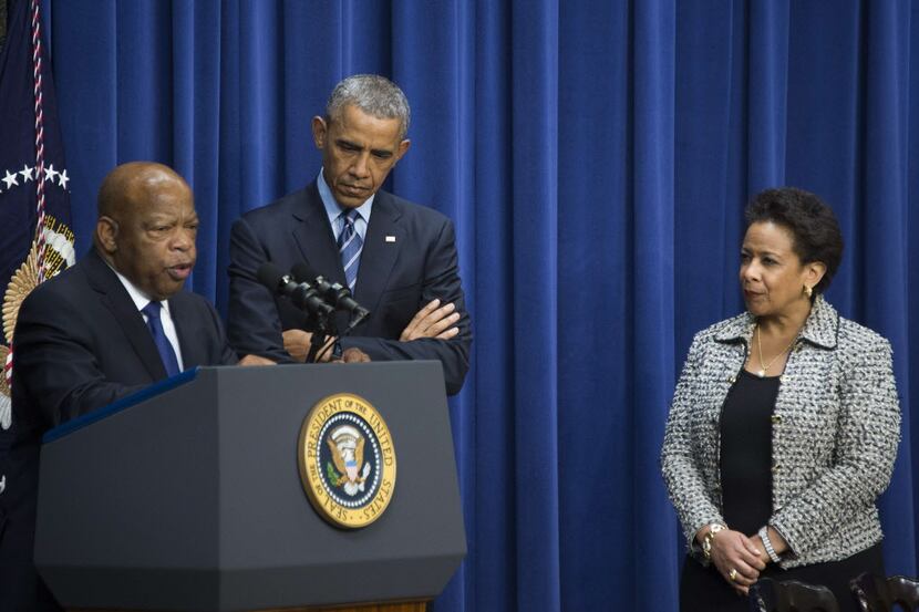  President Barack Obama and U.S. Attorney General Loretta Lynch (R) listen as US Congressman...