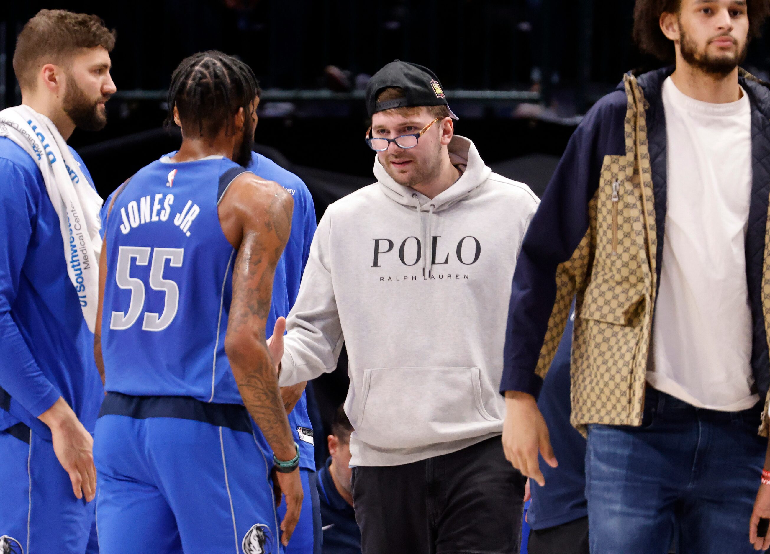 Dallas Mavericks guard Luka Doncic (77) put on a pair of someone else’s glasses as he...