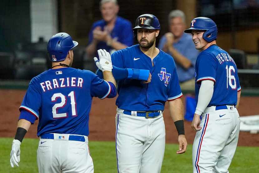 Texas Rangers first baseman Todd Frazier celebrates with Joey Gallo and Scott Heineman after...