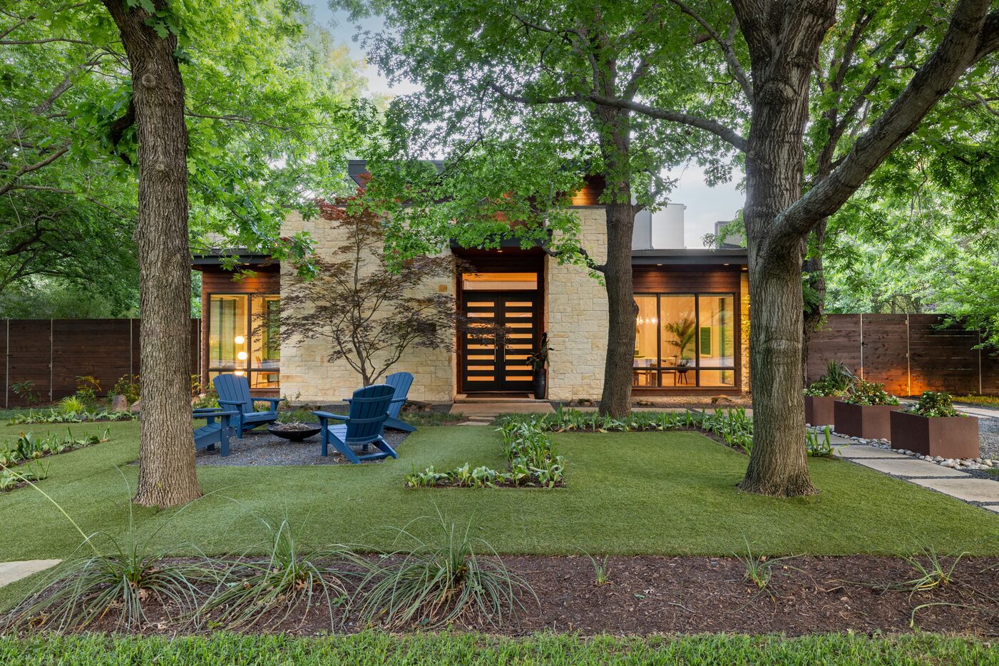 Exterior of contemporary home surrounded by trees, contemporary landscaping design