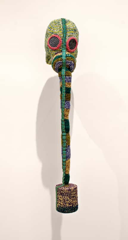 Nomin Bold's knitted gas masks are colorful and playful, belying the original intent of the...