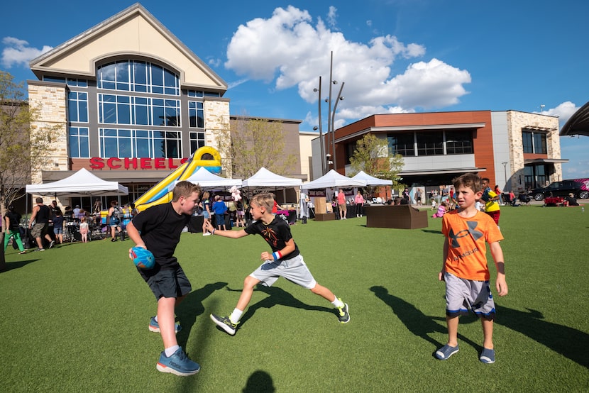 Thatcher Jones, left, and Zach Maris, center, play a game of 2 vs 2 man football on the...