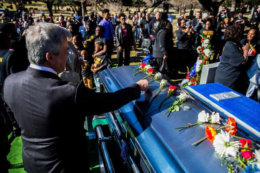 Austin Mayor Steve Adler places a flower on the casket of Richard Overton during a graveside...