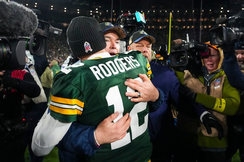 Dallas Cowboys head coach Mike McCarthy hugs Green Bay Packers quarterback Aaron Rodgers...