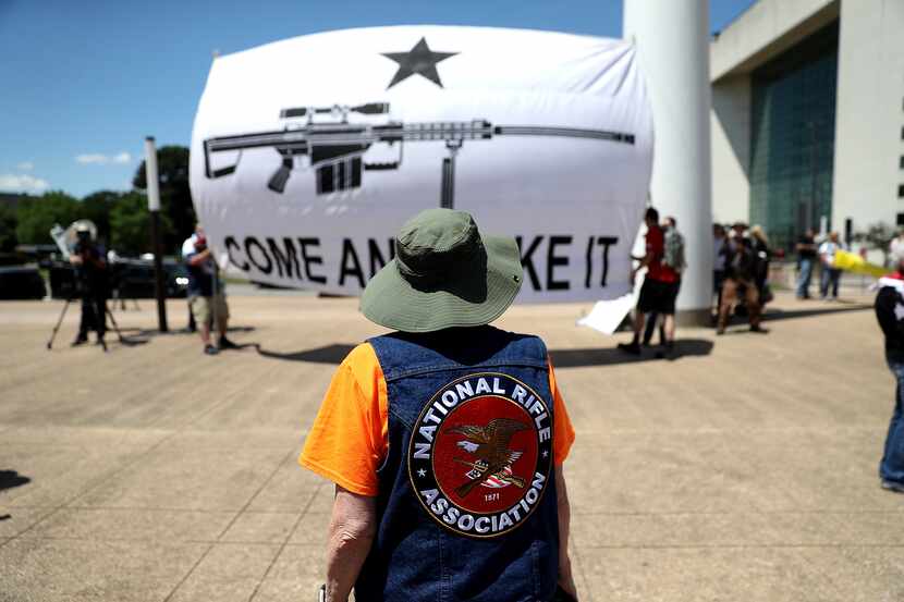 Gun rights advocates stage a demonstration outside of Dallas City Hall near the NRA Annual...