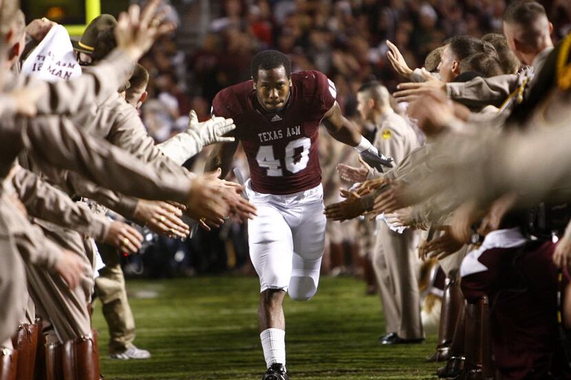 Texas A&M Aggies defensive end Von Miller (40) of DeSoto slaps hands with the Cadet Corps as...