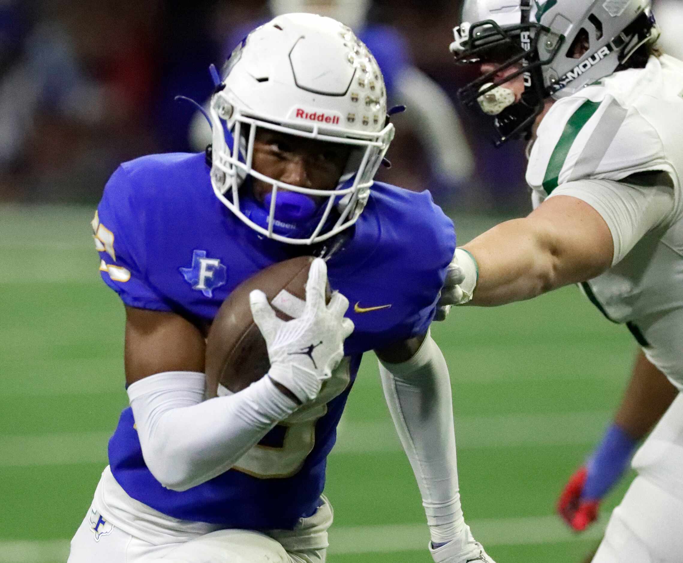 Frisco High School wide receiver Jaylen Archibald (23) carries the football during the first...