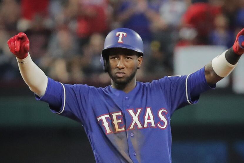 Texas Rangers shortstop Jurickson Profar (19) celebrates hitting a three-run double in the...