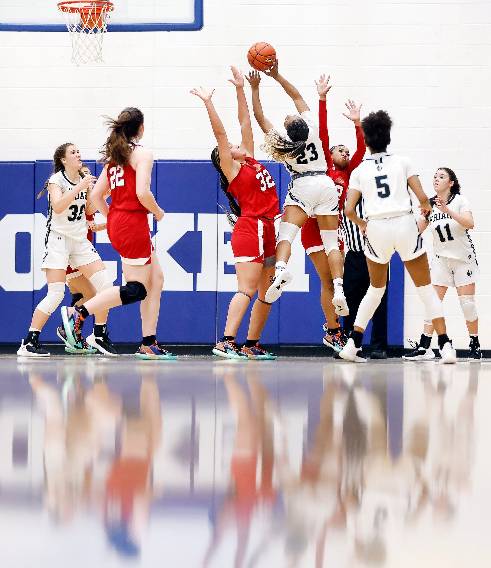 Bishop Lynch guard Mikah Ford (23) puts up a shot over John Paul II forward Allysia McDaniel...