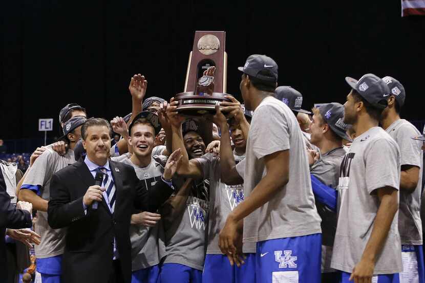 The University of Kentucky team with the NCAA Midwest Region trophy. The Kentucky Wildcats...