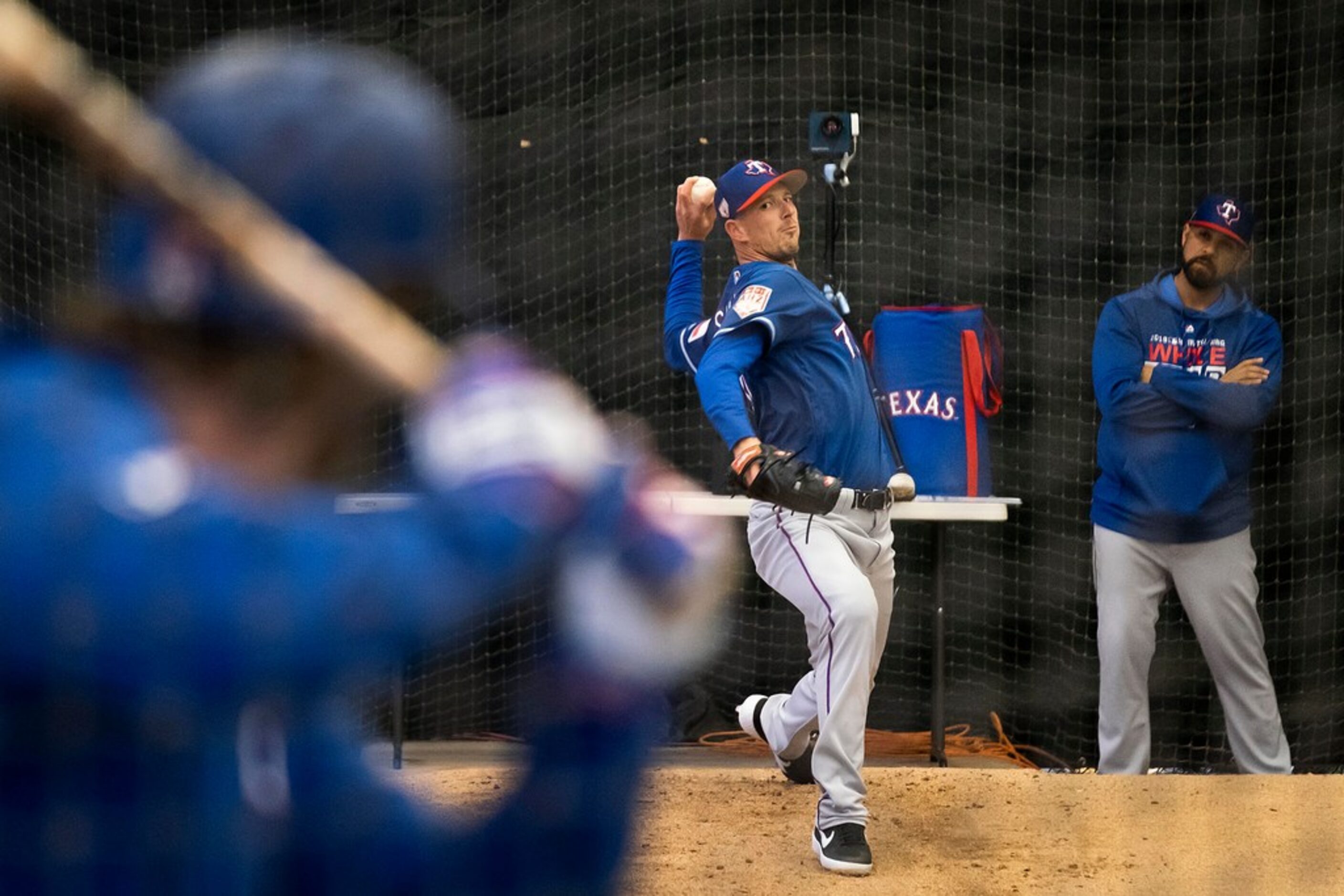 Texas Rangers pitcher Drew Smyly throws live batting practice to infielder Patrick Wisdom in...