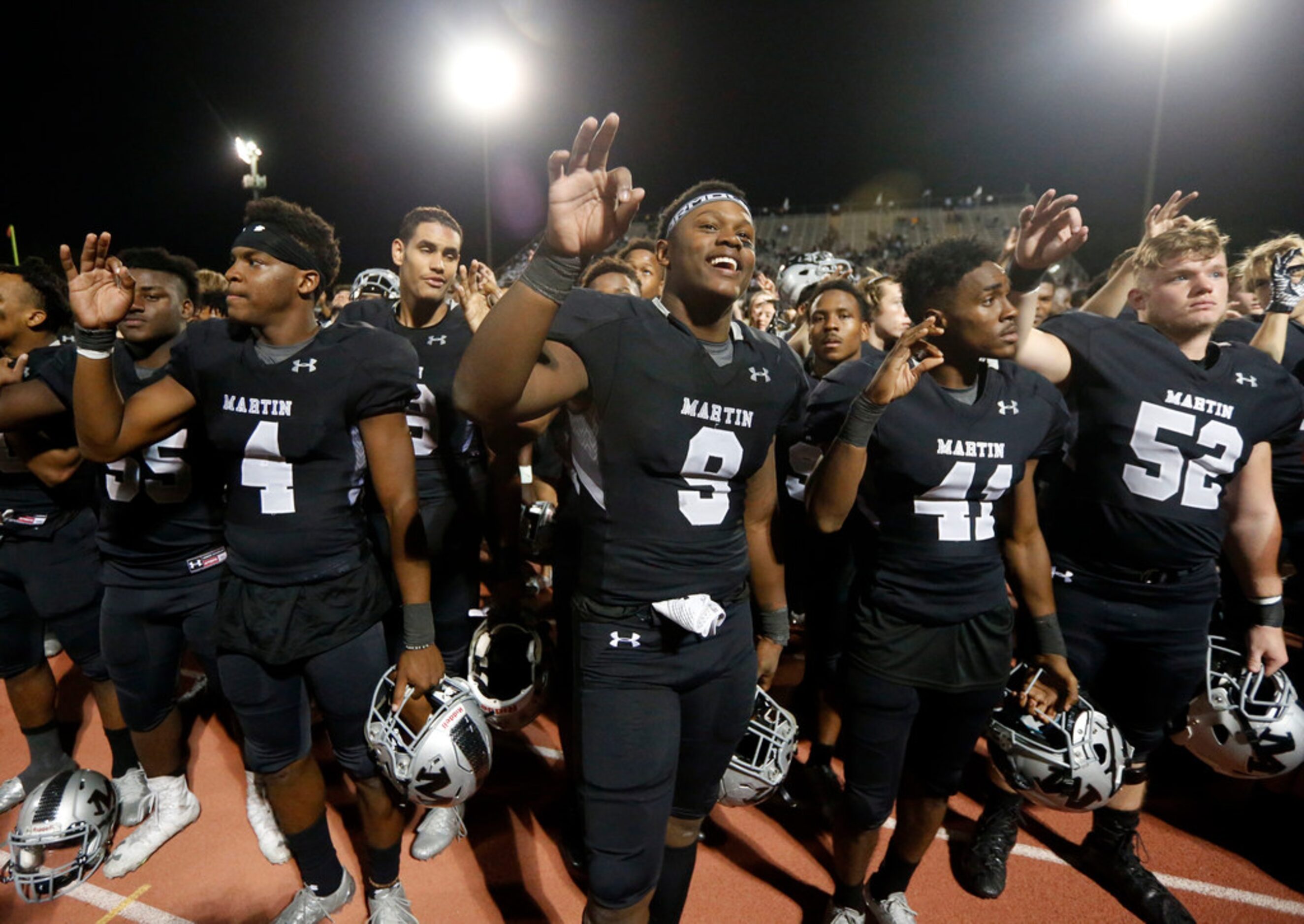 Arlington Martin players Jace Godley (4), Kelvin Spencer (9) and Jaylen Burleson (41) and...