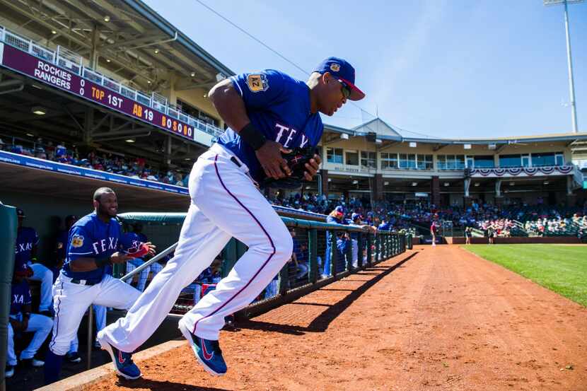 Texas Rangers third baseman Adrian Beltre (29) runs on to the field before a spring training...