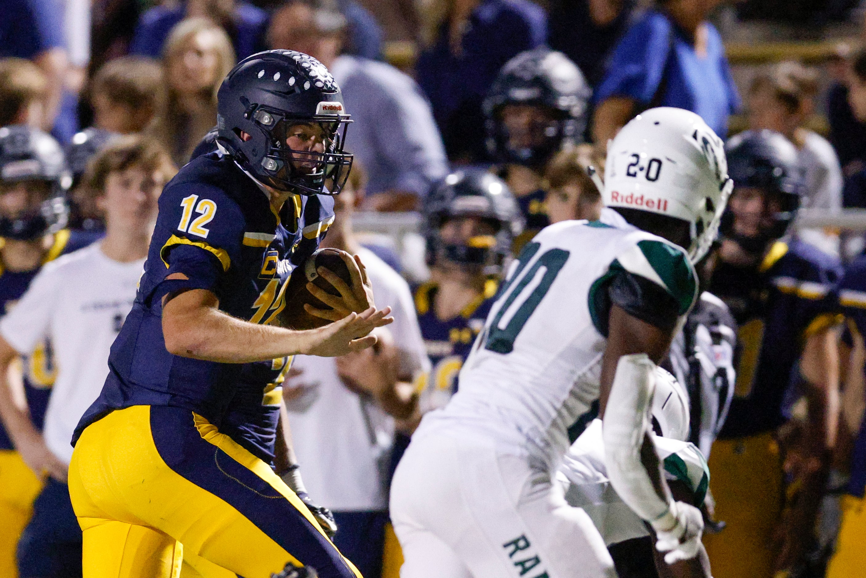 Highland Park quarterback Warren Peck (12) runs the ball during the first half of a District...