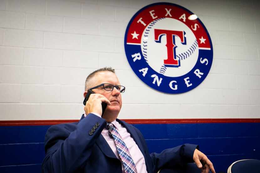 Texas Rangers Senior Director of Amateur Scouting Kip Fagg talks on the telephone after the...