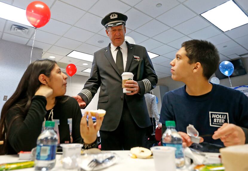 Capt. Jim Dees, Director of Flight with American Airlines, center, talks with Diana Lopez,...