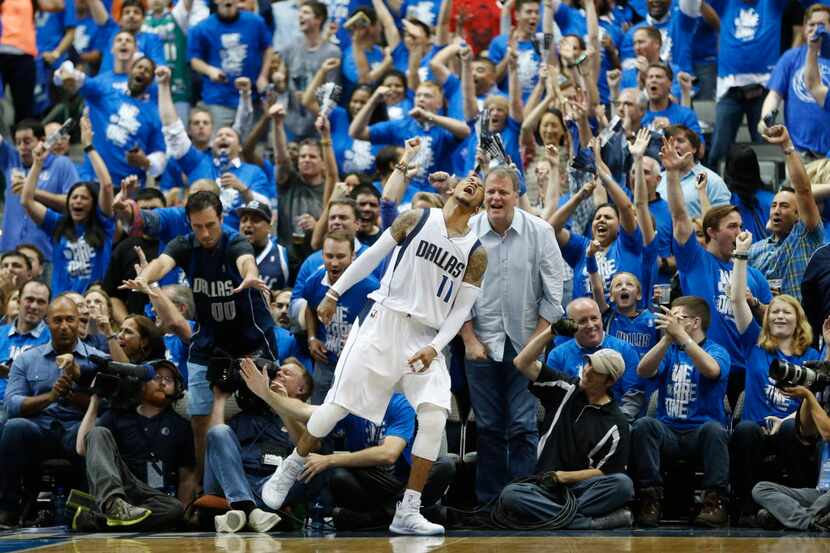 Dallas Mavericks guard Monta Ellis (11) celebrates in front of fans after making a basket...