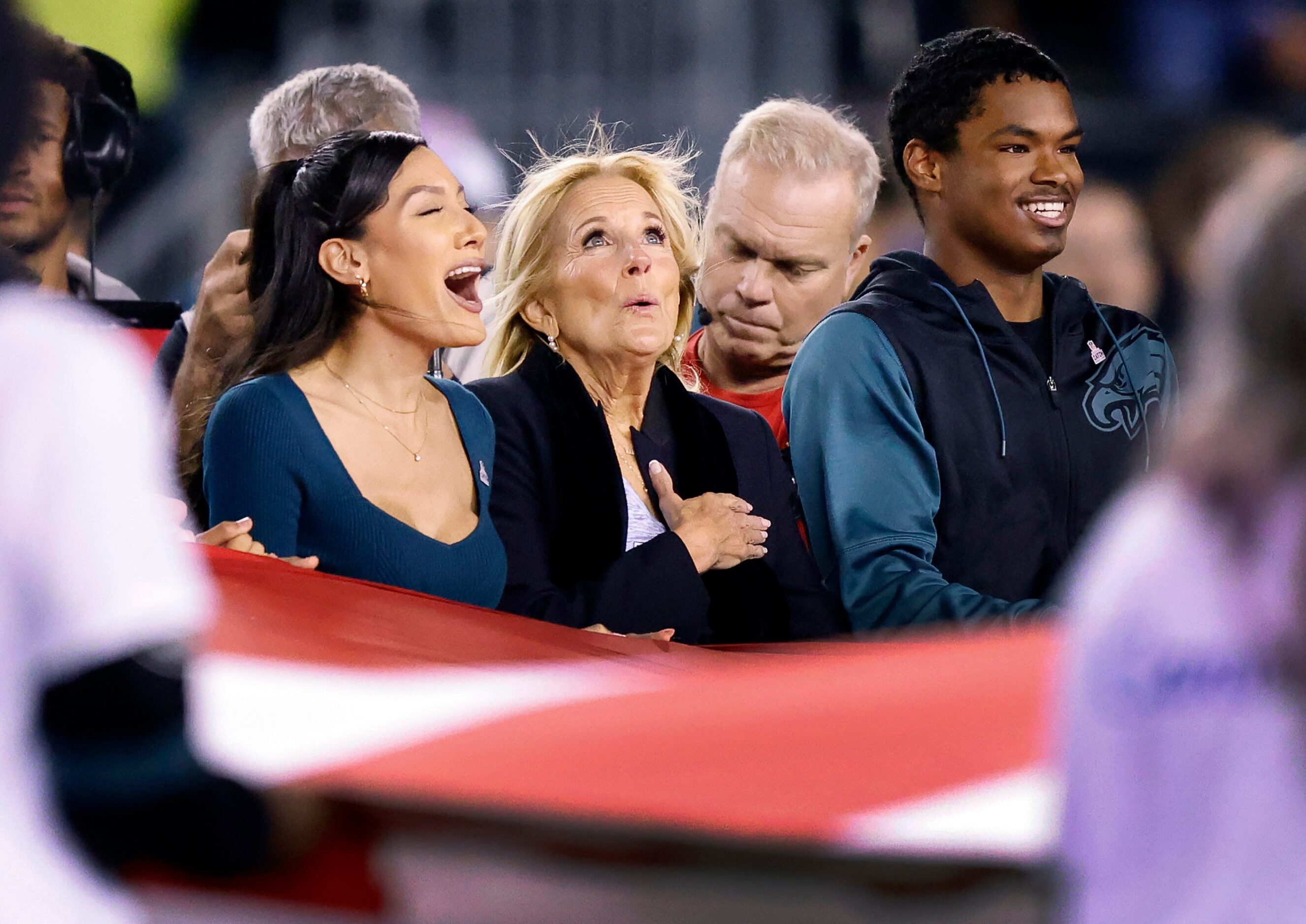 First Lady Dr. Jill Biden (center) reacts during the playing of the national anthem before...