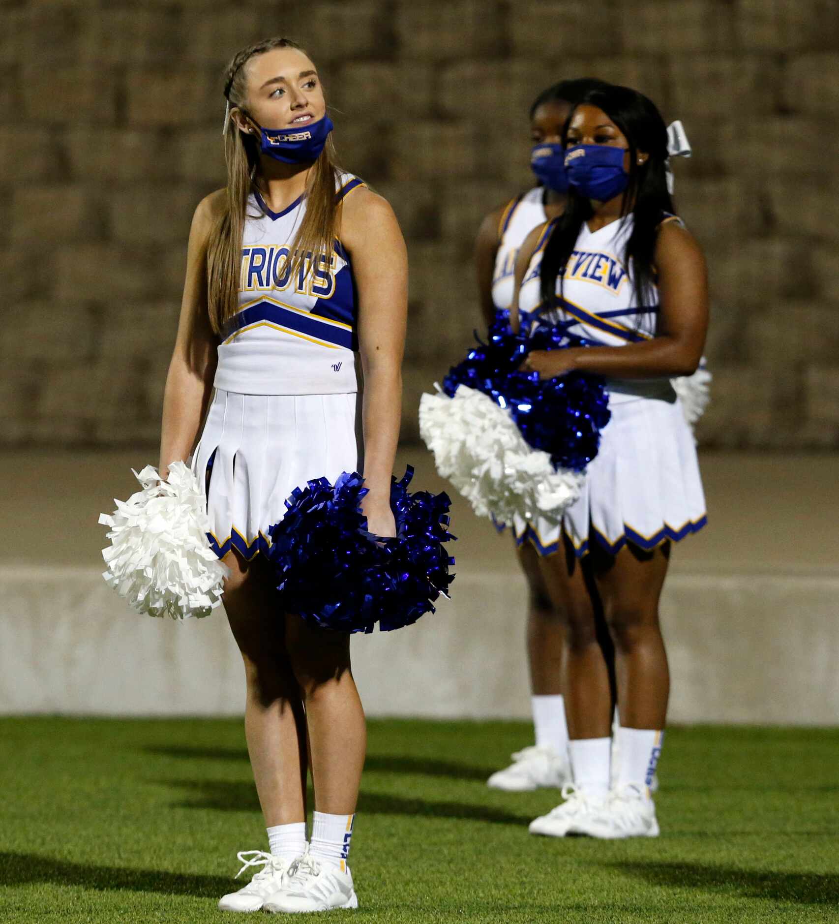 A Lakeview Centennial cheerleader takes a breath of fresh air during a break in the action...
