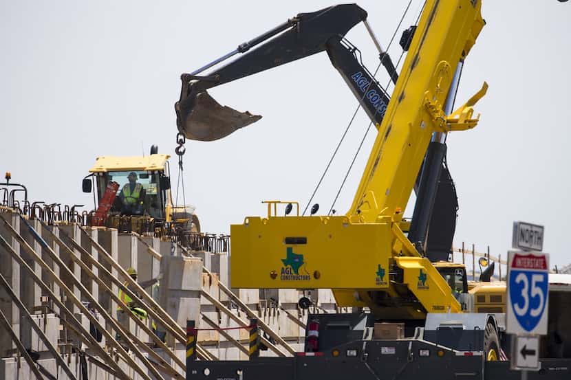 Construction crews work on a highway expansion project on I-35E just north of Lewisville...