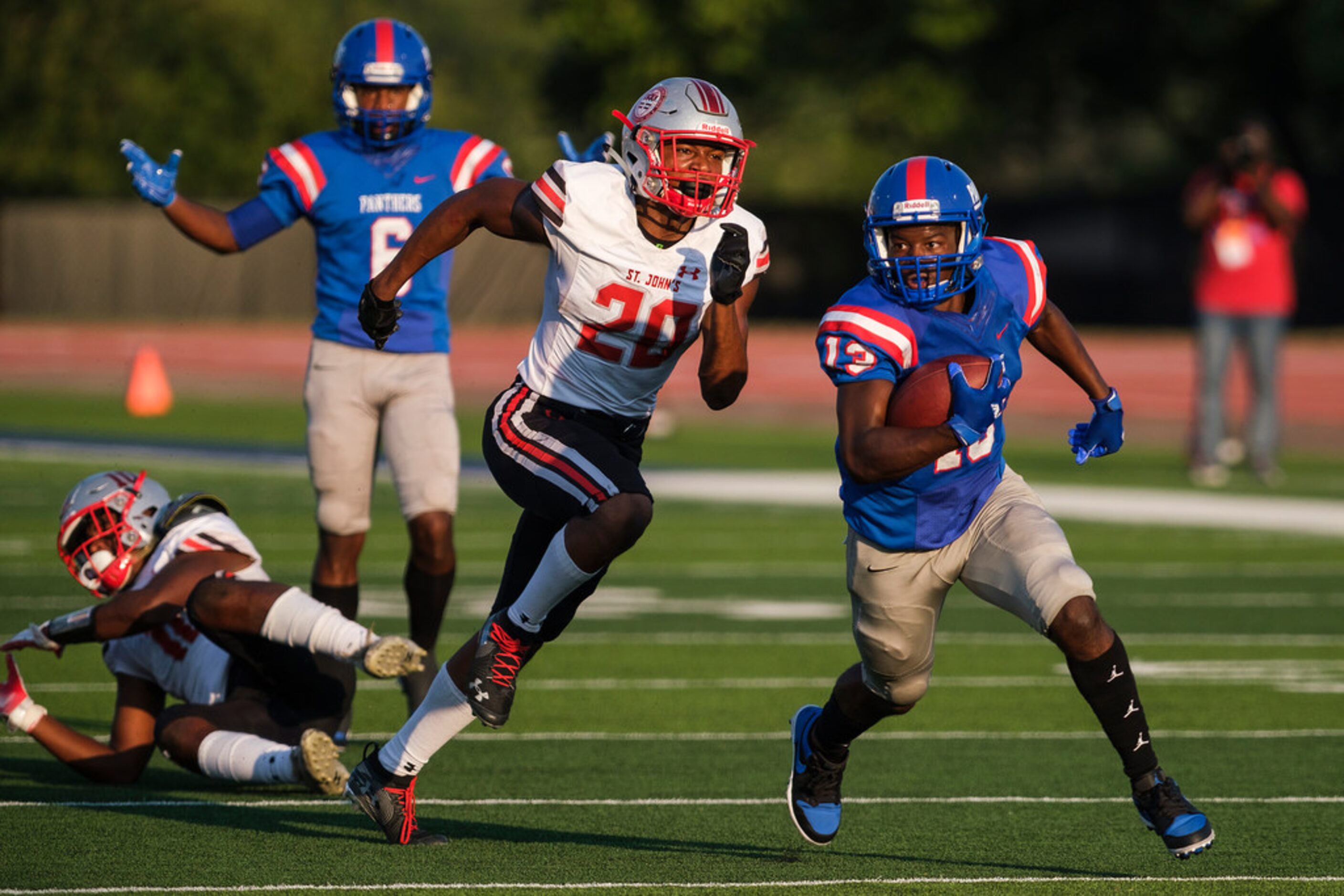 Duncanville wide receiver Roderick Daniels (13) races past St. John's College (D.C.)...