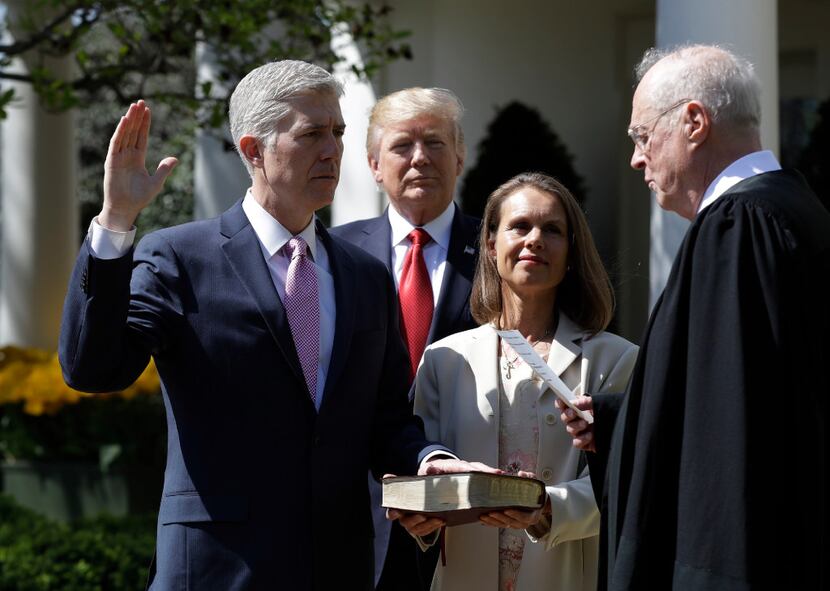 President Donald Trump watches as Supreme Court Justice Anthony Kennedy administers the...