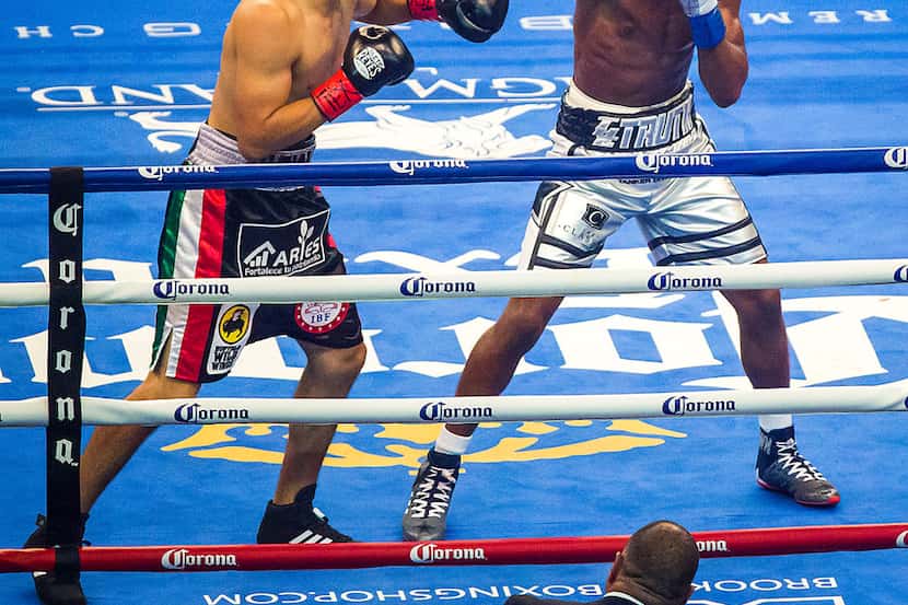 Welterweight champion Errol Spence Jr. lands punch on mandatory challenger Carlos Ocampo in...