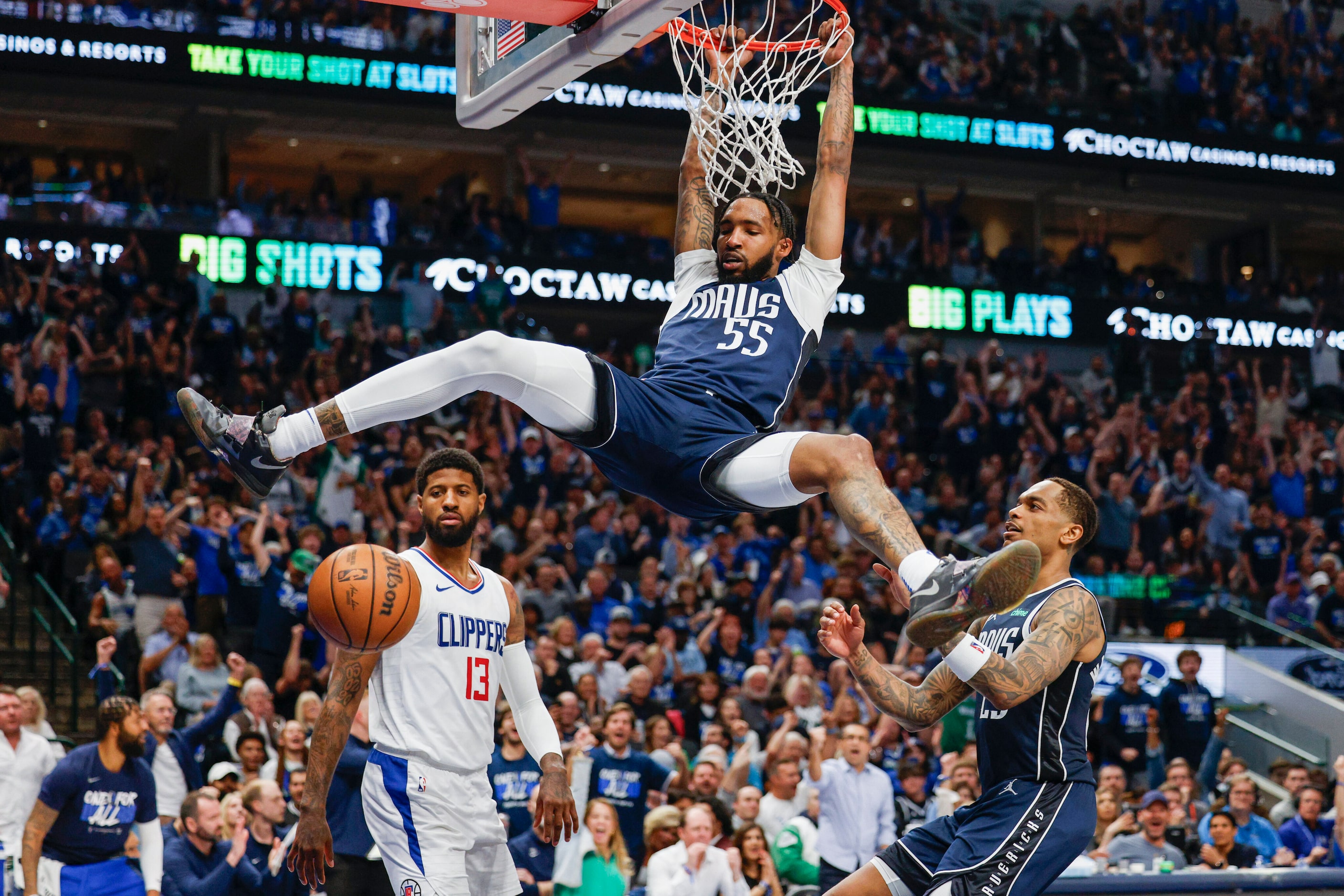 Dallas Mavericks forward Derrick Jones Jr. (55) dunks the ball as LA Clippers forward Paul...