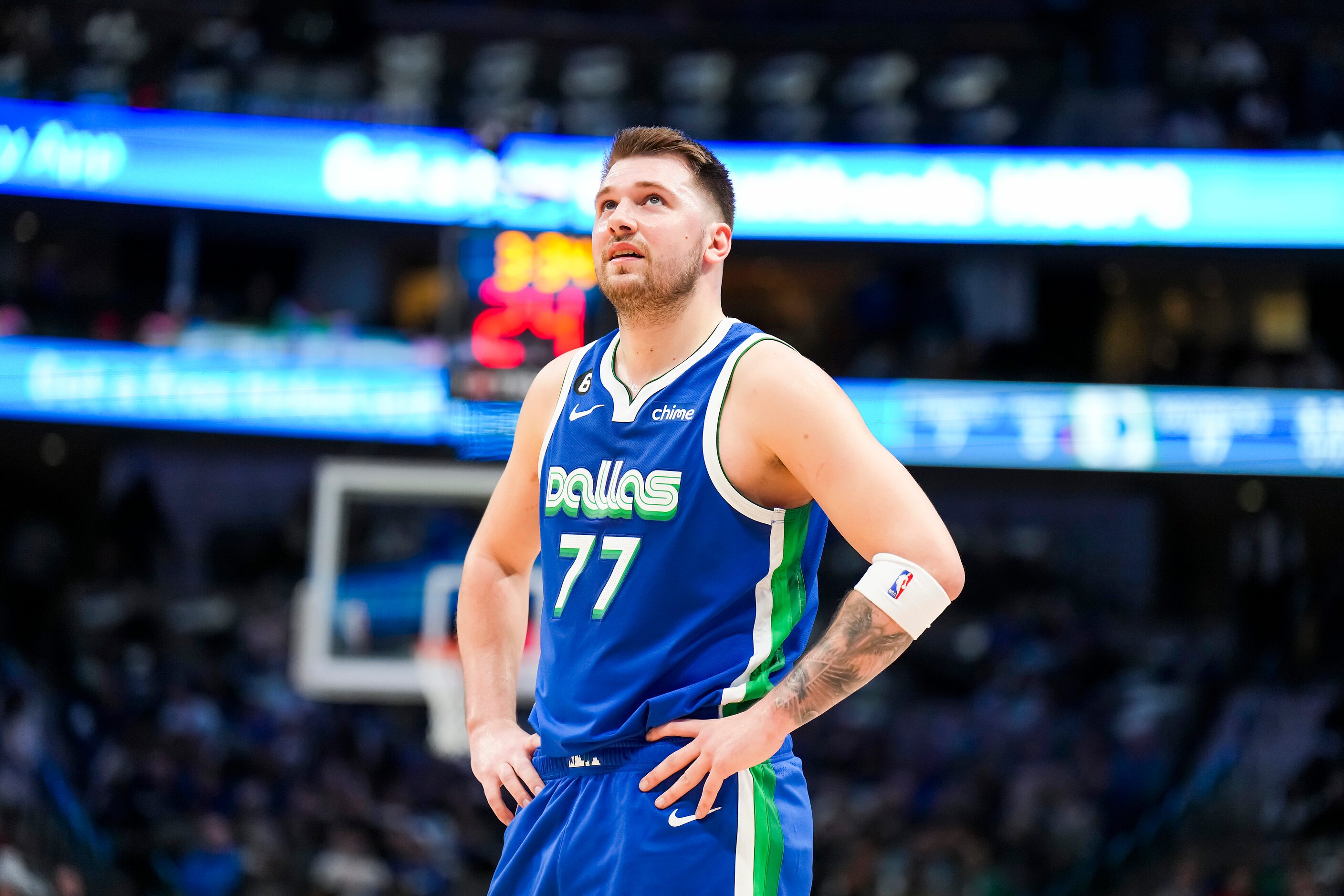 Dallas Mavericks guard Luka Doncic looks up at the scoreboard during the first half of an...