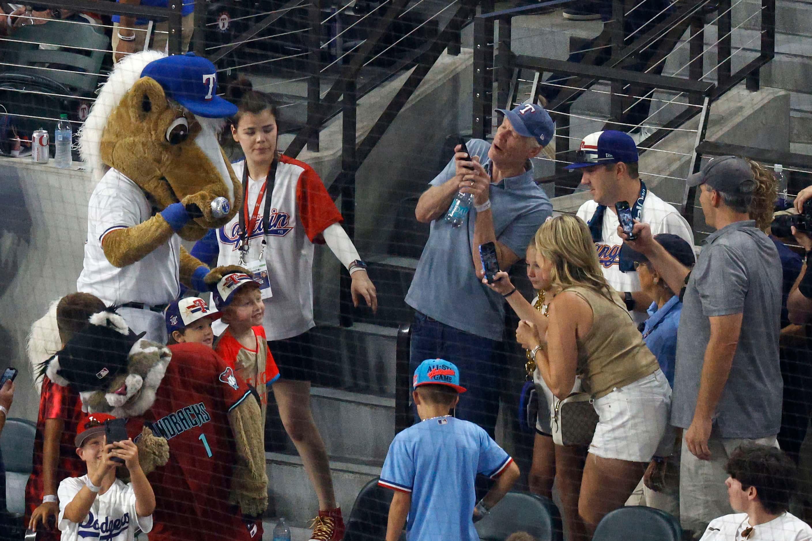 Rangers Captain, the mascot for the Texas Rangers, poses for a photo with fans during the...