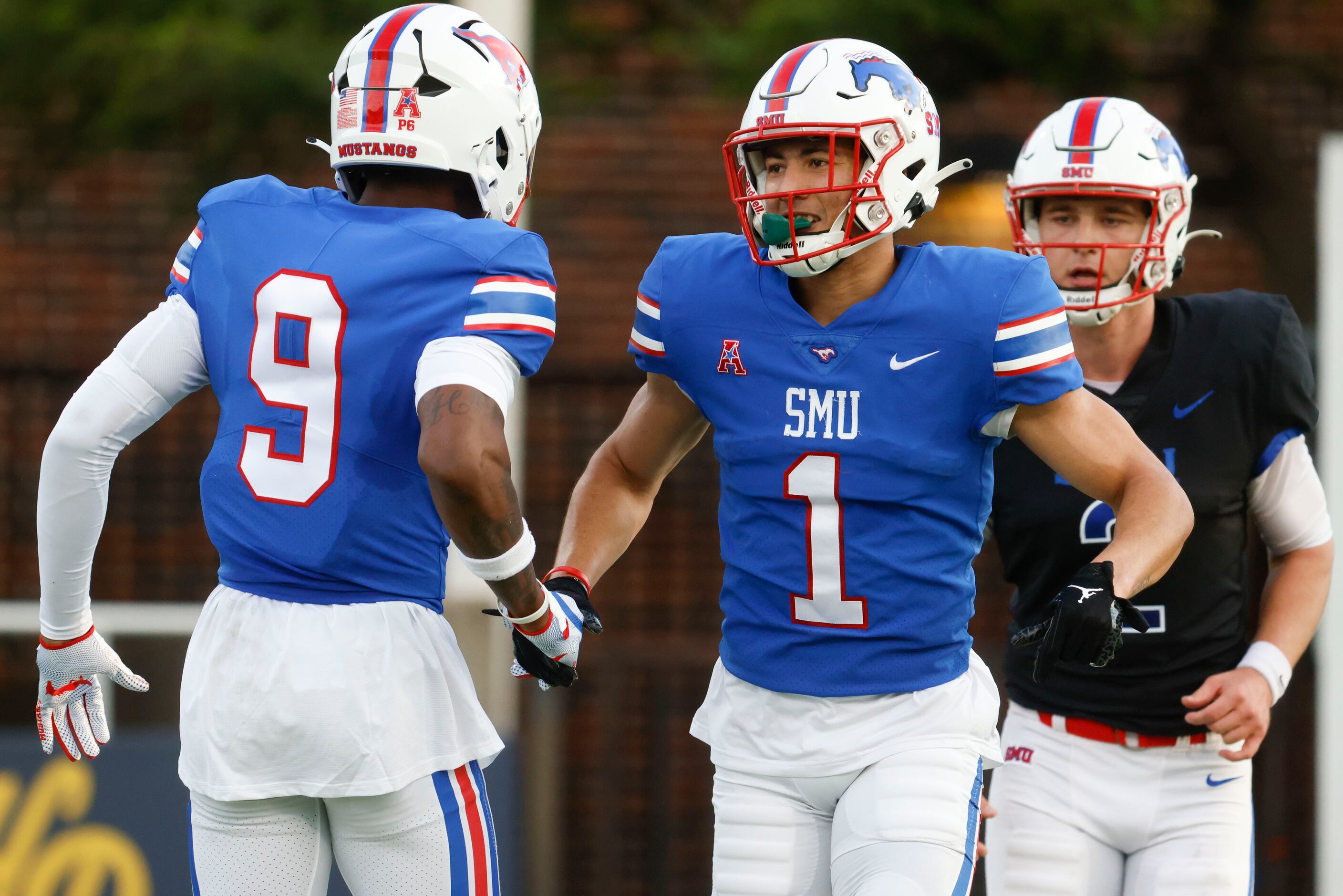 Southern Methodist defensive end Nelson Paul (left) cheers with Southern Methodist wide...