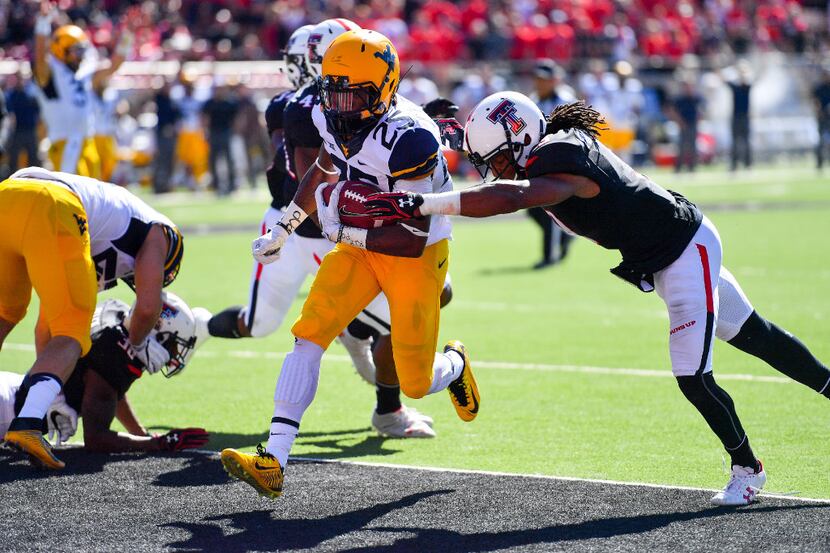 LUBBOCK, TX - OCTOBER 15: Justin Crawford #25 of the West Virginia Mountaineers scores...