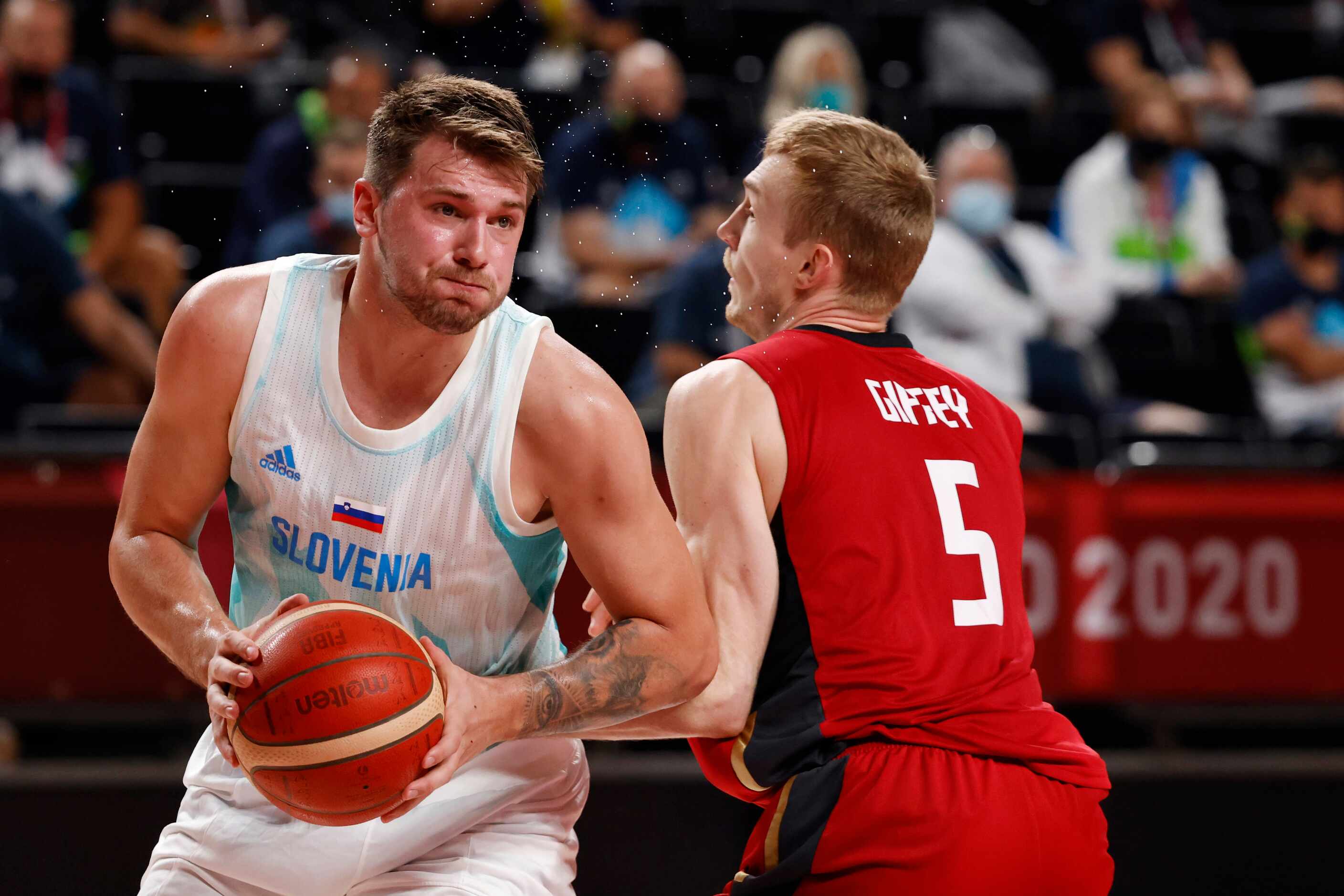 Slovenia’s Luka Doncic (77) drives on Germany’s Niels Giffey (5) during the first half of...