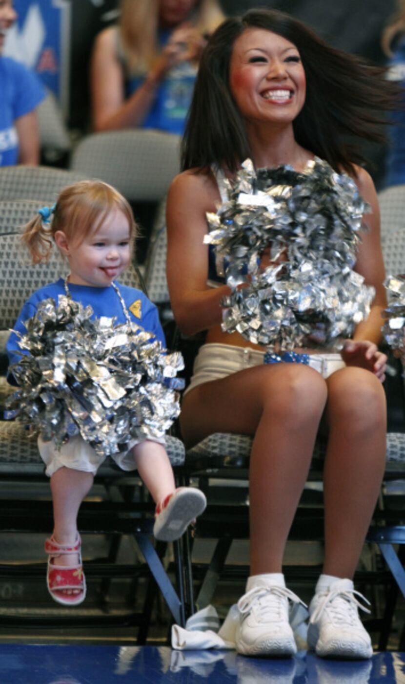 Mavericks Dancer Natsuki Kaito, right, sits with two-year-old Sevyn Tennison as they get...