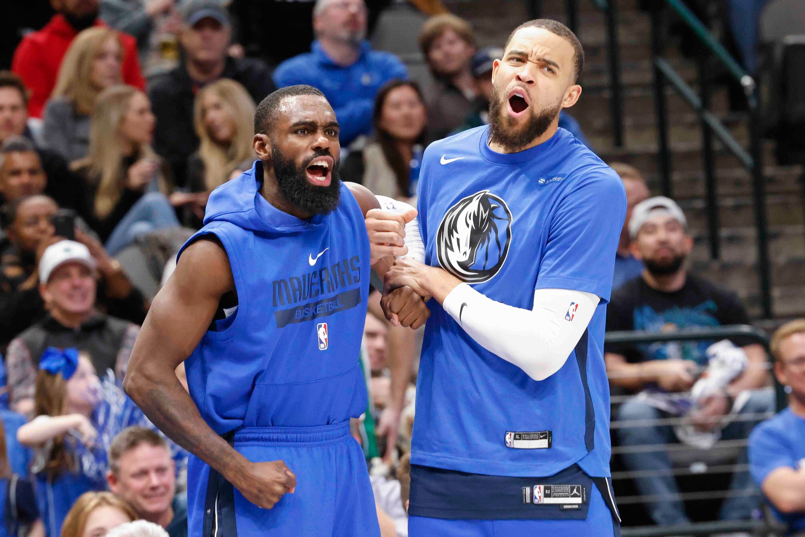 Dallas Mavericks forward Tim Hardaway Jr. (11), left, and center JaVale McGee (00) cheers...