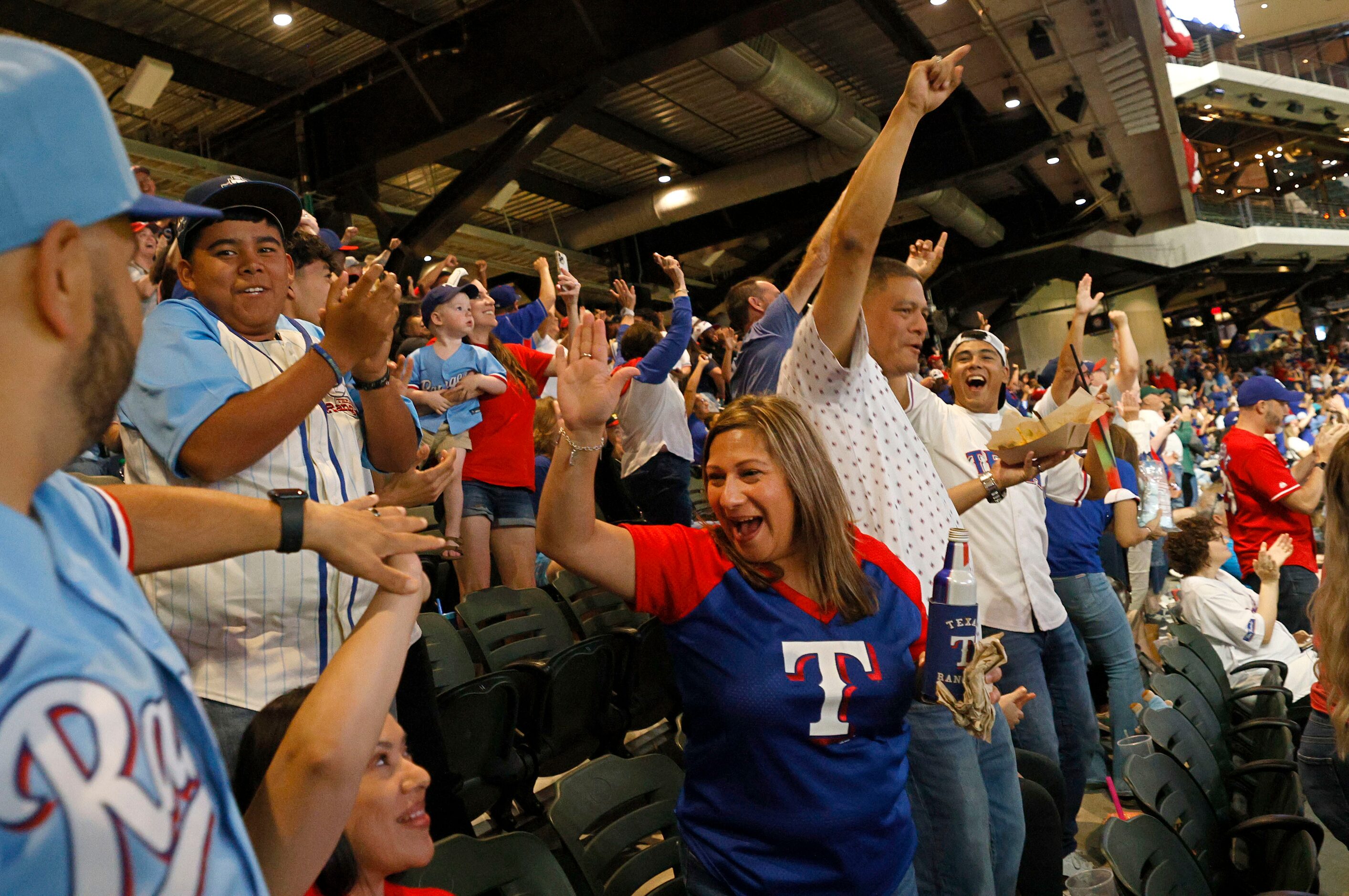 Texas Rangers fans react during a Game 7 watch party of the baseball American League...