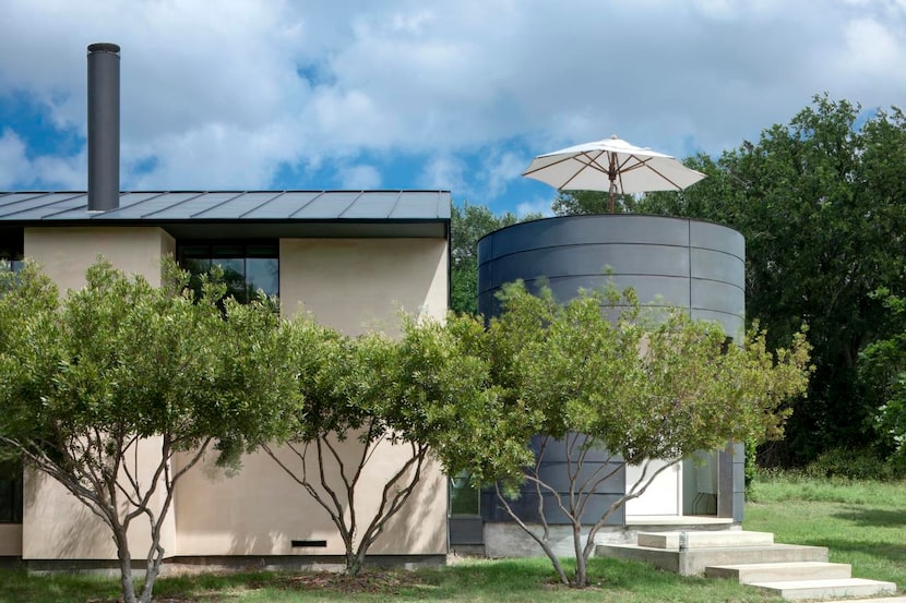 
The cylindrical entrance to the home is clad in galvanized steel and supports a martini...