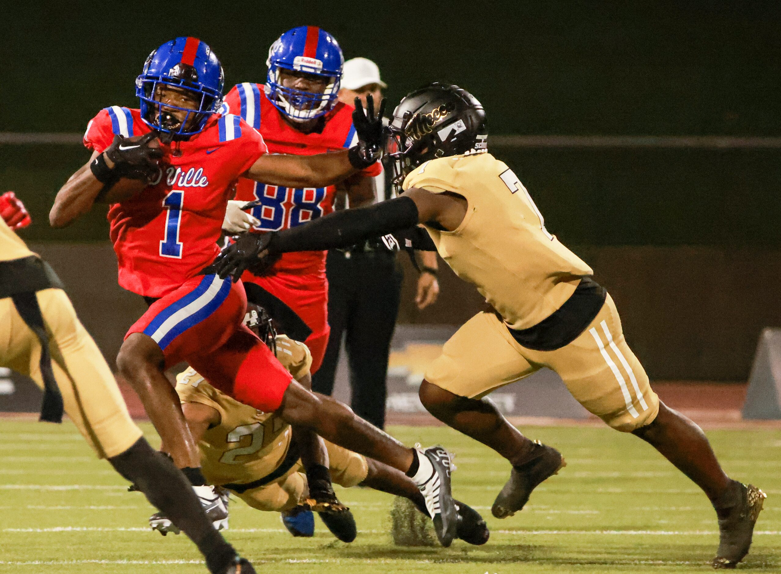 Duncanville High School Lontrell Turner (1) avoids a tackle by South Oak Cliff High School...